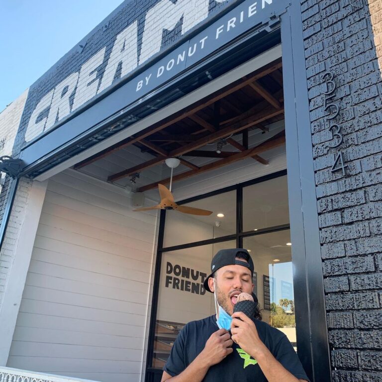 A man outside Creamo enjoying some ice cream