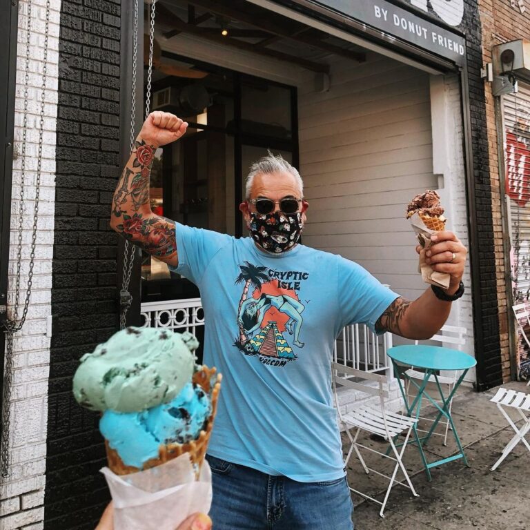 A man exiting Creamo with his ice cream
