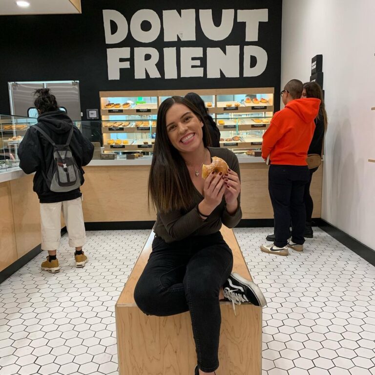 A woman posing with her ice cream inside Donut Friend