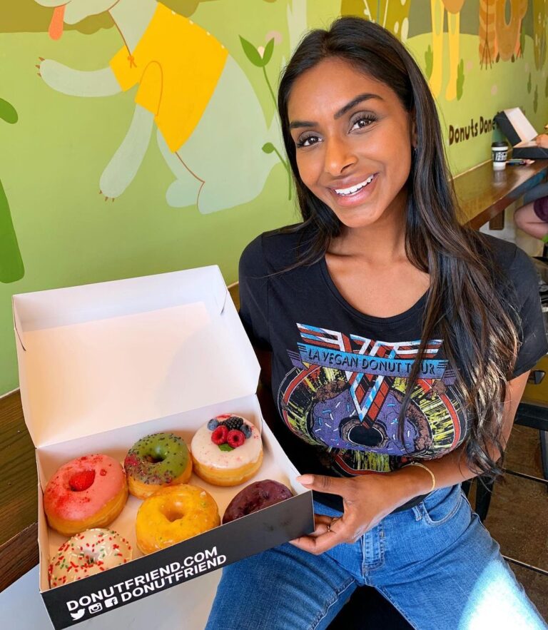 a woman posing with her donuts inside our HLP location