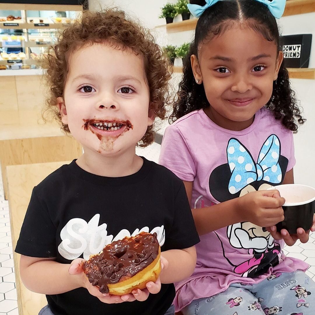 two kids enjoying their donuts