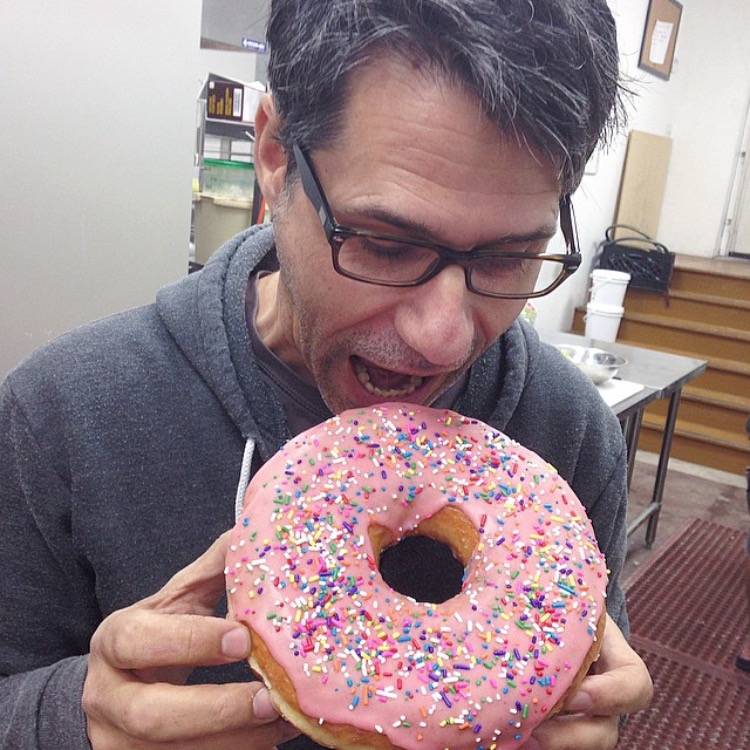A man eating a giant donut